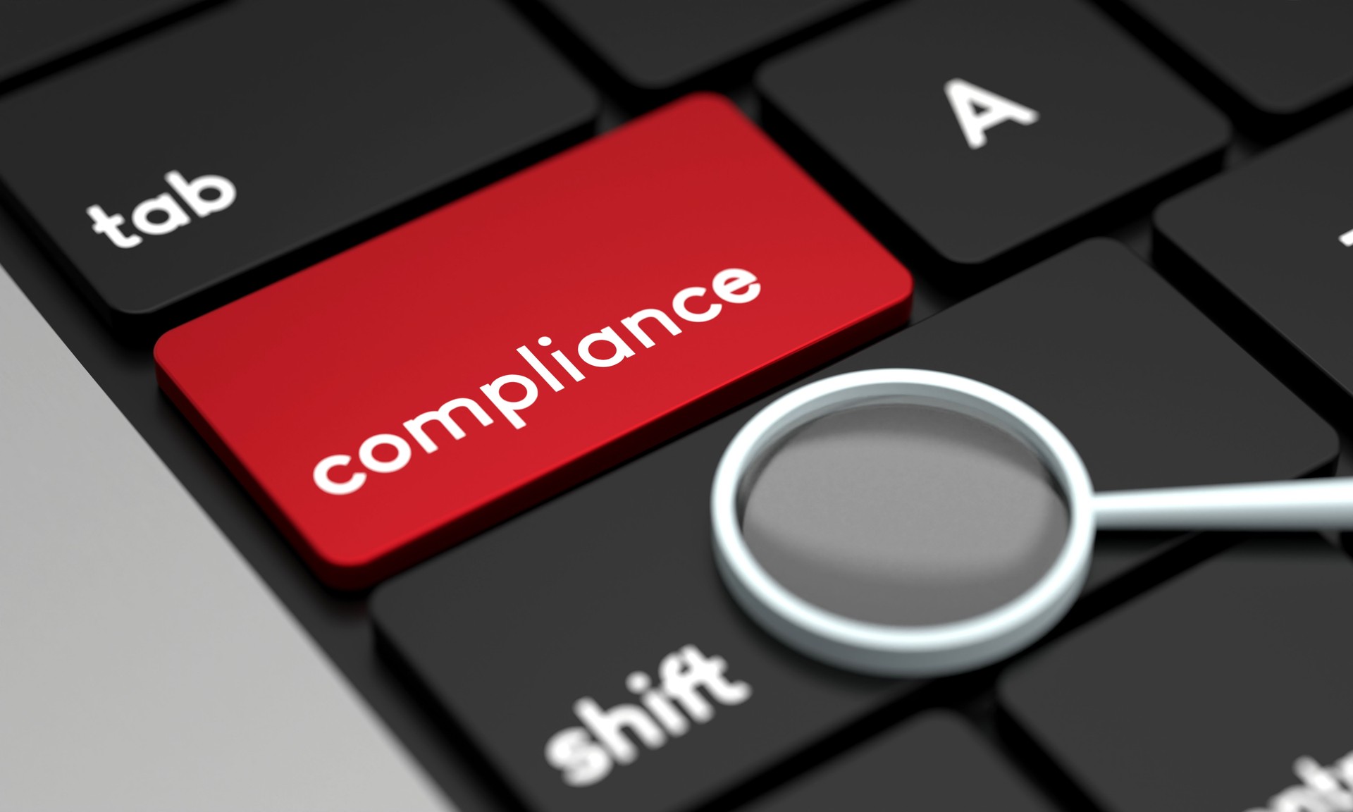Close-Up Laptop Keyboard With Compliance Button and magnifying glass